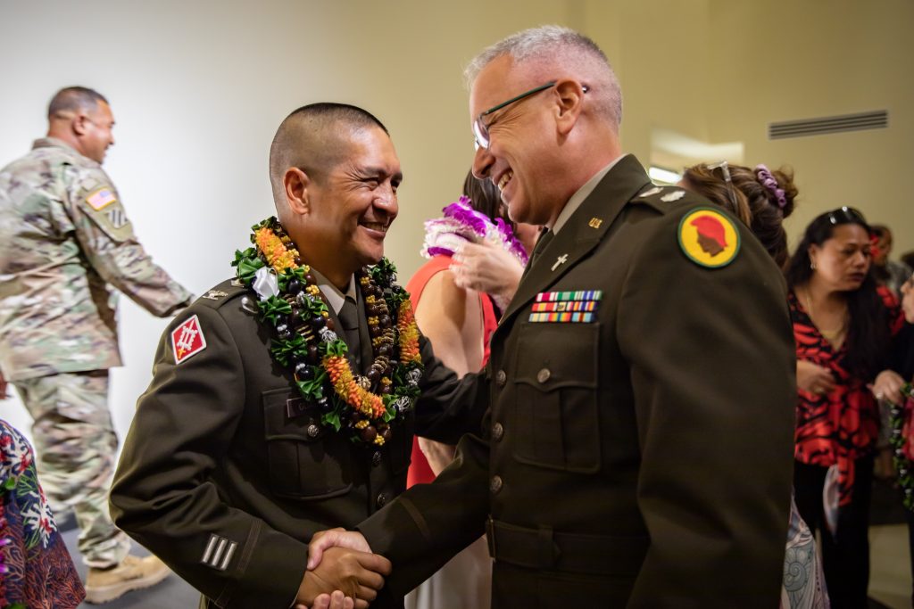 U.S. Army Chaplain (Col.) Christopher J. Guadiz, senior Army chaplain, Hawaii Army National Guard (HIARNG), Joint Force Headquarters, shakes hands with Chaplain (Lt. Col.) Charles Poore during his promotion ceremony at Kalaeloa, Hawaii, May 4, 2024. Guadiz direct commissioned as a Chaplain Candidate in 1997 and has served as a chaplain for over 25 years. (U.S. Army National Guard photo by Sgt. Lianne M. Hirano)