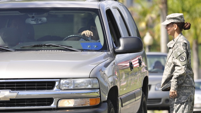 image of a guard speaking to a person in a vehicle