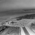 The second shows an aerial view of the compound, probably after the 1962 facility dedication. You can see how the F-102s parked on the flight line at an angle. Security was minimal – no fences anywhere.