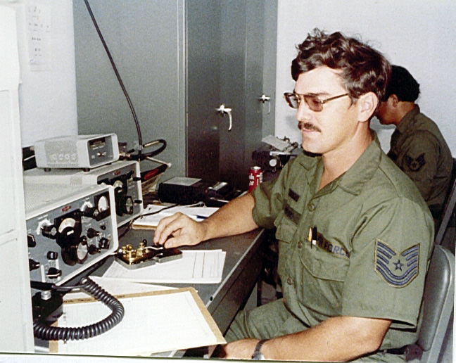This photograph shows a young Harold Scoggins, who served as a Traditional Guardmember in the 293d Combat Communications Squadron. The photograph was undated, but the fatigue uniform places it in the late 80s. He is practicing his Morse Code technique transmitting over a HF radio. Harold later served as the squadron First Sergeant and retired in the early 2000's.