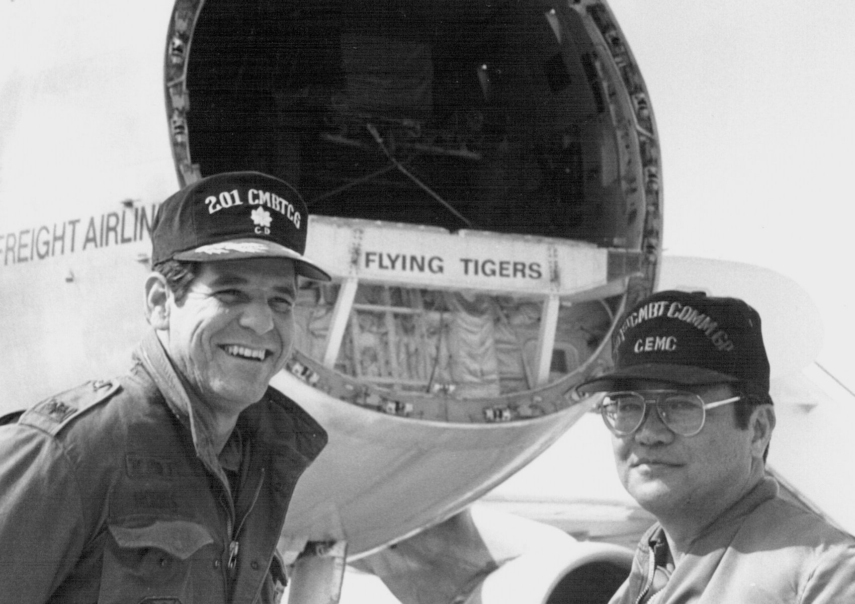 In the photograph, Lt. Col. Melvin Morris and CMSgt Clement Oshiro are on the Osan AB flightline. They observed the off loading of a Flying Tiger charter aircraft. Lt. Col. Morris was the Deputy Commander of the 201st Combat Communications Group and Chief Oshiro was the Maintenance Superintendent of the 201st Combat Communications Squadron in Hilo.
