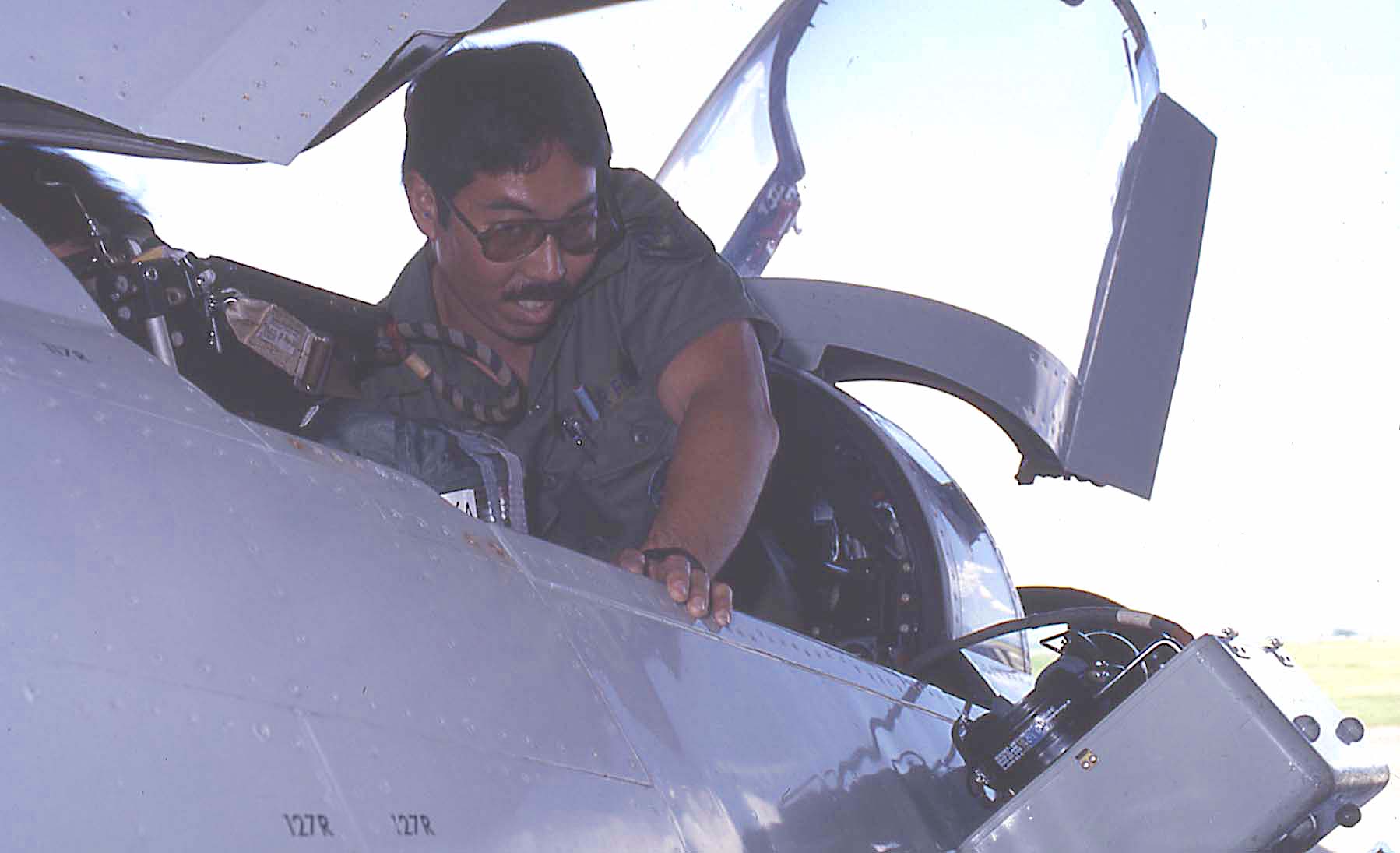 This photograph shown Craig Harimoto, conducting an operational check on a F-4 Phantom II. Craig was part of the Egress Shop, and later became the shop chief. Later in his career, he moved to Quality Control section. He retired as a chief master sergeant.