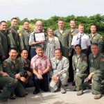 Photo: Peter Clark, Ann Greenlee and Kristof Sills. Also pictured are the many current and former Hawaii Air National Guard pilots working and flying for Hawaiian Airlines.