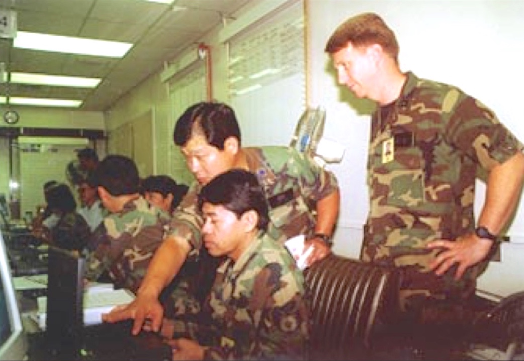 In the undated photograph, shows three members of the 201st Combat Communications Group (201 CCG). Lt Col Blaine Izuka, SSgt Patrick Bailon and Capt Michael Doolin review situation reports during a Makani Pahili  exercise.