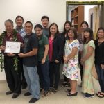 Gerald Takase (second from left) receives an Employer Support of the Guard and Reserve Patriot Award. Tech Sgt. Nestor Cacho, Hawaii Air National Guard, (holding the Patriot Award) nominated Takase for the award. Also pictured are the staff of the Hawaii County Liquor Commission