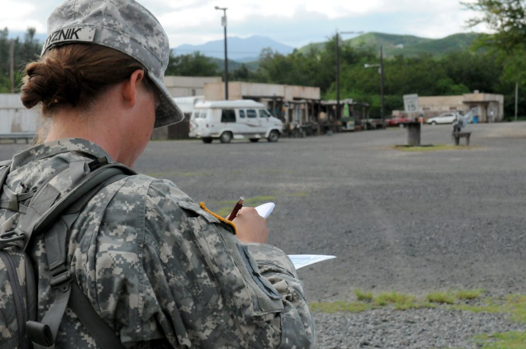 U.S. Army Sgt. Kelly Tyznik, Company Alpha, 29th Brigade Support Battalion, plots her next point on the land navigation (day) course during the Hawaii Army National Guard Best Warrior Competition March 1, 2014 held at 298th Multi-Functional Regional Training Institute, Waimanalo, Hawaii. (U.S. Army National Guard photo by Staff Sgt. Ryan Sheldon/Released)