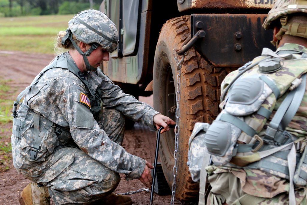 Staff Sgt. Krysta M. Waters of the 111th Army Band change a tire of a High Mobility Multipurpose Wheeled Vehicle during a mystery event at the Best Warrior Competition at Schofield Barracks, Hawaii, March 3, 2018. The Best Warrior Competition recognizes Soldiers who demonstrate commitment to the Army Values, embody the Warrior Ethos, and represent the Force of the Future. (U.S. Army National Guard photo by Pfc. Chavaughn Washington/Released)