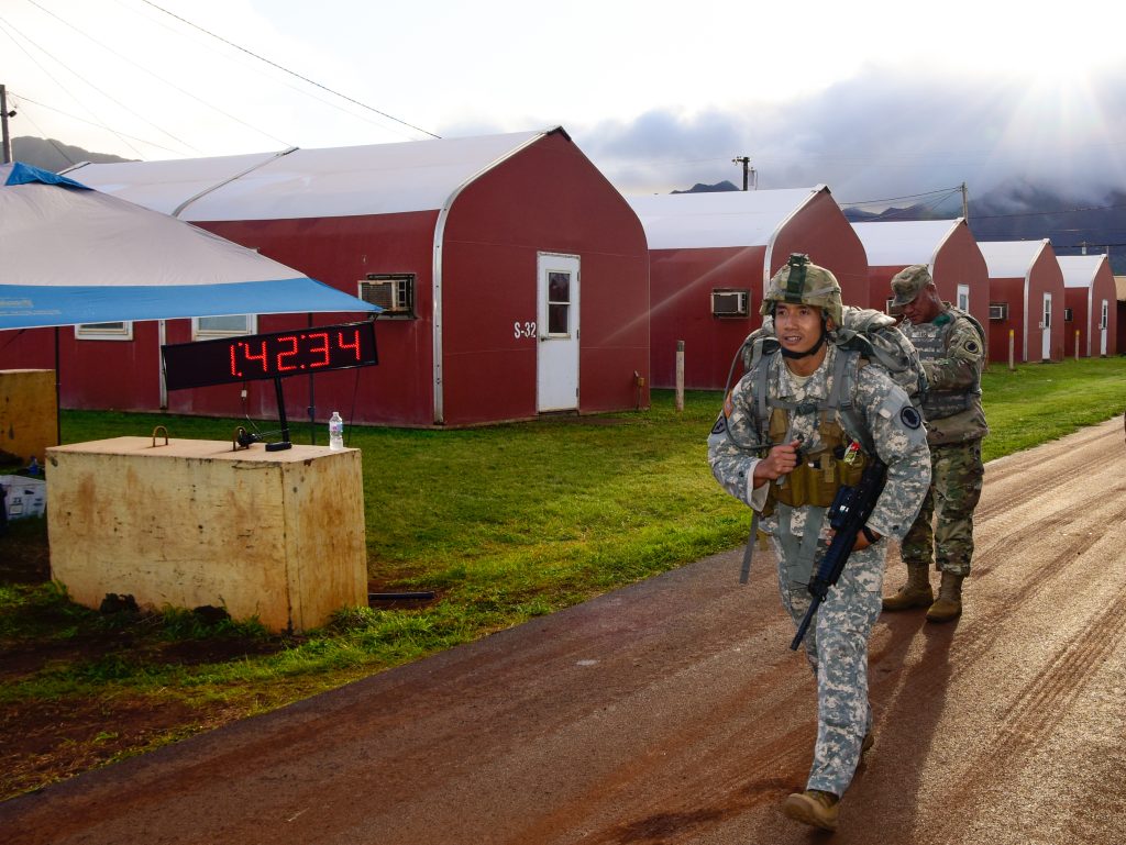 Staff Sgt. Paulo Napoles with the Recruiting and Retention Battalion, Hawaii Army National Guard continues the road march after reaching the turn-around point during the Best Warrior Competition on Schofield Barracks, Hawaii, March 1, 2019. Soldiers are challenged during this three-day competition involving a combat pistol qualification enabling Soldiers to engage targets while moving, an M4 qualification, land navigation, weapon assembly, road march, written exam, appearance board and multiple scenario-based warrior tasks. (Hawaii Army National Guard photo by Sgt. 1st Class Theresa Gualdarama)