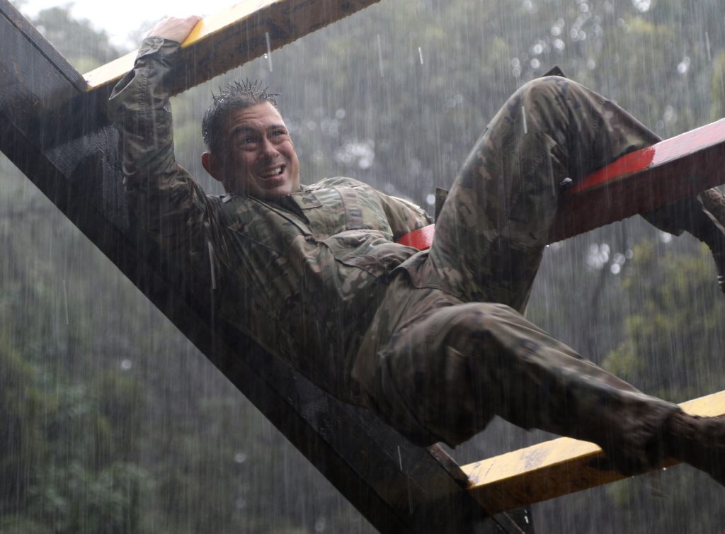 Hawaii Army National Guard Sgt. Eric R. Binger participates in the weaver during the 2021 Hawaii Best Warrior Competition (BWC) obstacle course event at Schofield Barracks, Hawaii, March 6, 2021. The BWC is an annual three day event that Soldiers and Non-Commissioned Officers of the Hawaii Army National Guard and Hawaii Army Reserve compete in to earn the title of "Best Warrior". The BWC tests the Soldiers' individual ability to adapt and overcome challenging scenarios and battle-focused events, testing their technical and tactical skills under stress and extreme fatigue. (U.S. Army National Guard photo by Sgt. Lianne M. Hirano)