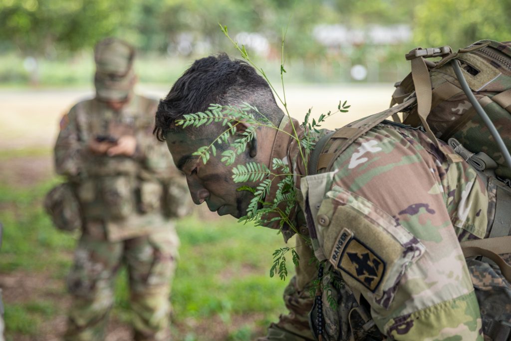 U.S. Army Spc. Andruw Nakamura, an infantryman assigned to Charlie Troop, 1st Squadron, 299th Cavalry Regiment, 9th Infantry Brigade Combat Team, Hawaii Army National Guard (HIARNG) applies camouflage during the HIARNG 2024 Best Warrior Competition at the Regional Training Institute, Waimanalo, Hawaii, April 5-7, 2024. The Best Warrior Competition is an annual event conducted by the HIARNG to identify the most skilled and proficient Soldiers across various military occupational specialties (MOS). (U.S. Army National Guard photo by Sgt. Lianne M. Hirano)