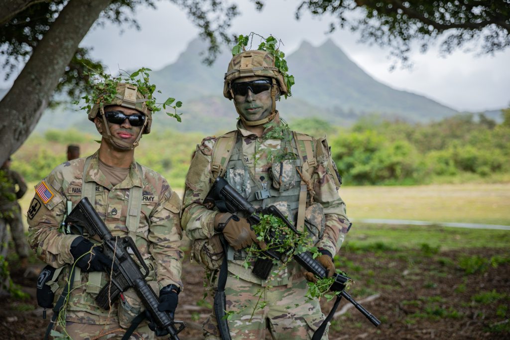 U.S. Army Staff Sgt. Bradley Padama-Kinere, left, a combat medic specialist assigned to Headquarters Headquarters Battalion, 1st Battalion, 487th Field Artillery Regiment, 29th Infantry Brigade Combat Team, Hawaii Army National Guard (HIARNG) and Spc. Andruw Nakamura, an infantryman assigned to Charlie Troop, 1st Squadron, 299th Cavalry Regiment, 9th Infantry Brigade Combat Team, HIARNG, pose for a photo during the HIARNG 2024 Best Warrior Competition at the Regional Training Institute, Waimanalo, Hawaii, April 5-7, 2024. The Best Warrior Competition is an annual event conducted by the HIARNG to identify the most skilled and proficient Soldiers across various military occupational specialties (MOS). (U.S. Army National Guard photo by Sgt. Lianne M. Hirano)