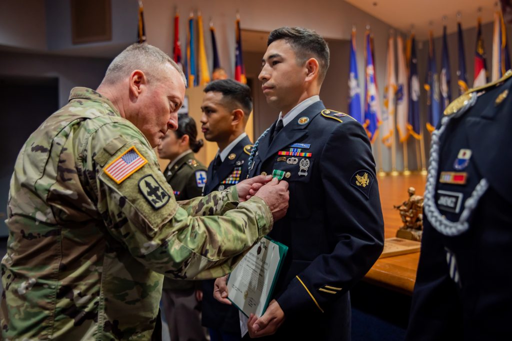 U.S. Army Brig. Gen. Stephen F. Logan, left, assistant adjutant general for the State of Hawaii, Hawaii Army National Guard (HIARNG), awards Spc. Andruw Nakamura, an infantryman assigned to Charlie Troop, 1st Squadron, 299th Cavalry Regiment, 9th Infantry Brigade Combat Team, HIARNG, for winning Soldier of the Year during the HIARNG 2024 Best Warrior Competition at the Regional Training Institute, Waimanalo, Hawaii, April 5-7, 2024. The Best Warrior Competition is an annual event conducted by the HIARNG to identify the most skilled and proficient Soldiers across various military occupational specialties (MOS). (U.S. Army National Guard photo by Sgt. Lianne M. Hirano)