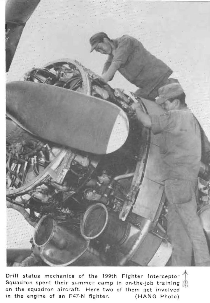 Drill status mechanics of the 199th Fighter Interceptor Squadron spent their summer camp in on-the-job training on the squadron aircraft. Here two of them get involved in the engine of an F47-N fighter. (HANG Photo)
