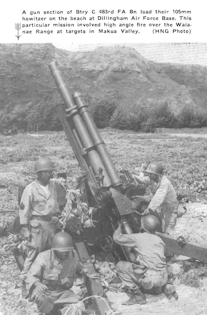 A gun section of Btry C 483rd FA Bn load their 105mm howitzer on the beach at Dillingham Air Force Base, This particular mission involved high angle fire over the Waia­nae Range at targets in Makua Valley, (HNG Photo)