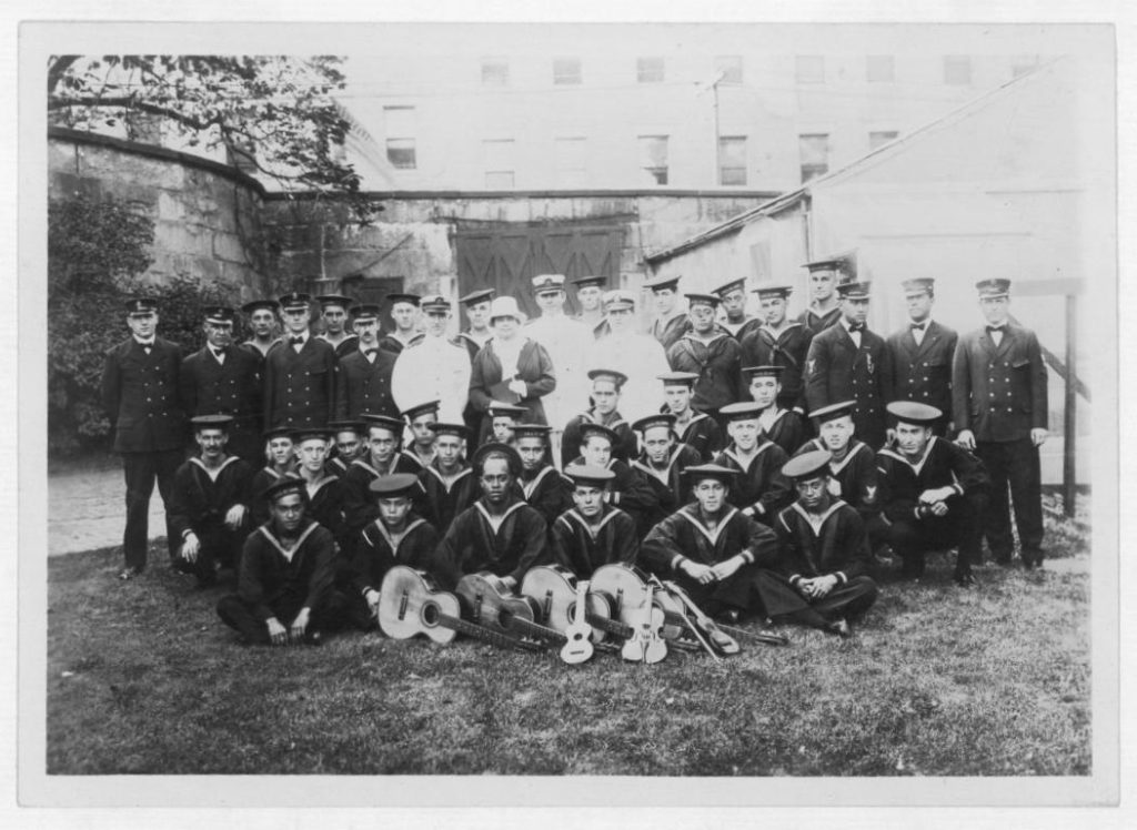 National Guard Naval Militia - Hawaii Naval Militiamen Serving on the USS. ST. Louis - Former Hawaii Naval Militiamen serving in USS St, Louis entertained at a picnic party by Mrs. Rush (Former Jennie Hare), wife of Capt. William R. Rush, USN, Cmdt of Boston Navy Yard during WWI. Center (L to R) lt. Com. S.W. King, Mrs. Rush, Lt. (J.g.) J.A. Mckeown, Ensign H. W. Engel