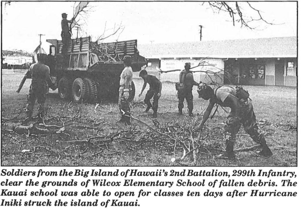 Soldiers from the Big Island of Hawaii's 2nd Battalion, 299th Infantry, clear the grounds of Wilcox Elementary School of fallen debris. The Kauai school was able to open for classes ten days after Hurricane lniki struck the island of Kauai.