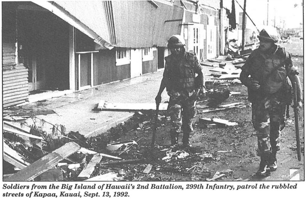 Soldiers from the Big Island of Hawaii's 2nd Battalion, 299th Infantry, patrol the rubbled streets of Kapaa, Kauai, Sept. 18, 1992.