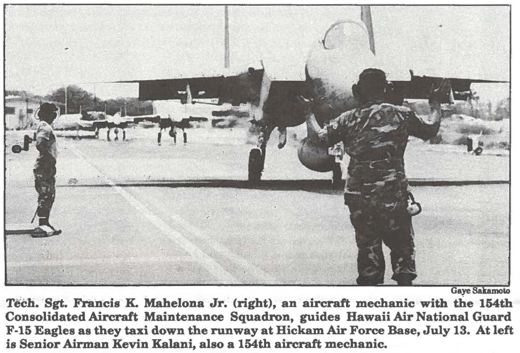Tech. Sgt. Francis K. Mahelona Jr. (right), an aircraft mechanic with the 154th Consolidated Aircraft Maintenance Squadron, guides Hawaii Air National Guard is Senior Airman Kevin Kalani, also a 154th aircraft mechanic.