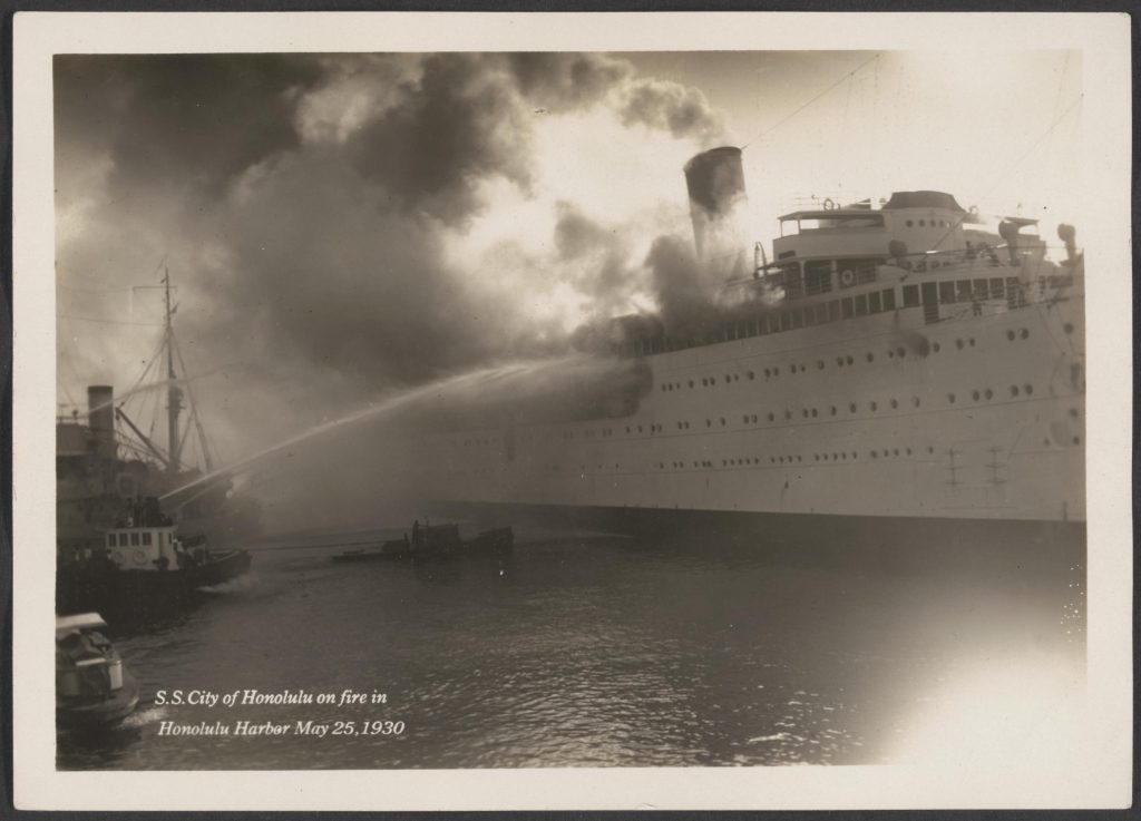 Ships - S.S. City of Honolulu - On fire in Honolulu Harbor, May 25, 1930. Fire boat putting out fire