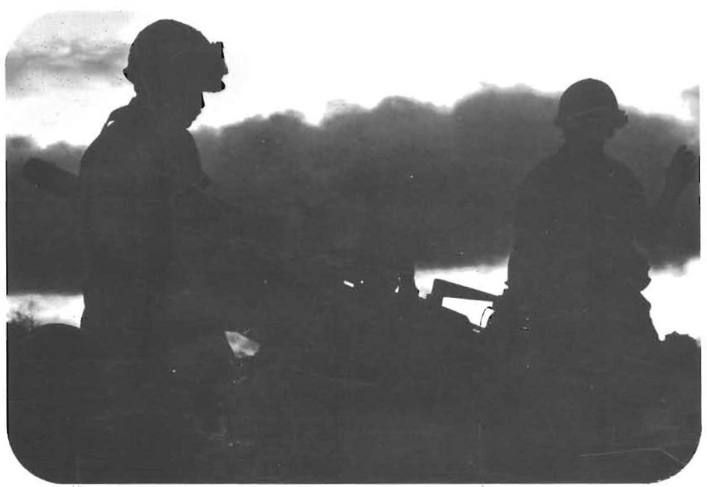 Night Fire – Troops of the Hawaii Army National Guard’s 487th Field Artillery prepare to fire a round from their 102-millimeter howitzer. Night fire is a part of every artilleryman’s qualification during Annual Training ’75 at Pohakuloa Training Area, Hawaii.