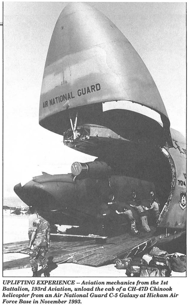 UPLIFTING EXPERIENCE -- Aviation mechanics from the 1st Battalion, 193rd Aviation, unload the cab of a CH-47D Chinook helicopter from an Air National Guard C-5 Galaxy at Hickam Air Force Base in November 1993.