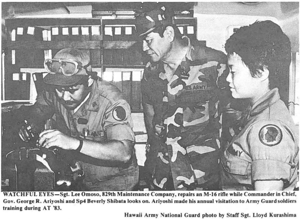 WATCHFUL EYES-Sgt. Lee Omoso, 829th Maintenance Company, repairs an M-16 rifle while Commander in Chief, Gov. George R. Ariyoshi and Sp4 Beverly Shibata looks on. Ariyoshi made his annual visitation to Army Guard soldiers training during AT '83. Hawaii Army National Guard photo by Staff Sgt. Lloyd Kurashima
