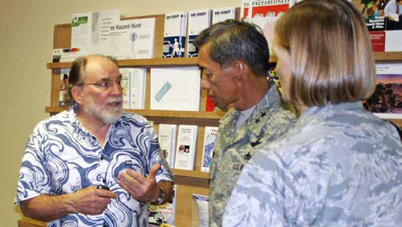 NEW TEAM TESTED – Gov. Neil Abercrombie confers with Maj. Gen. Darryll D.M. Wong, the adjutant general, and Brig. Gen. Ann Greenlee, the interim Hawaii Air National Guard commander. during the Japan earthquake generated tsunami. Capt. Jeffry D. Hickman photo