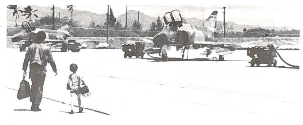 Capt. Dave Talbert gets a big helping hand from his son as he makes his way to the flightline.