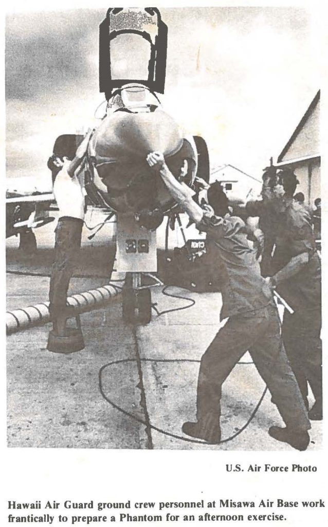 Hawaii Air Guard ground crew personnel at Misawa Air Base work frantically to prepare a Phantom for an afternoon exercise.