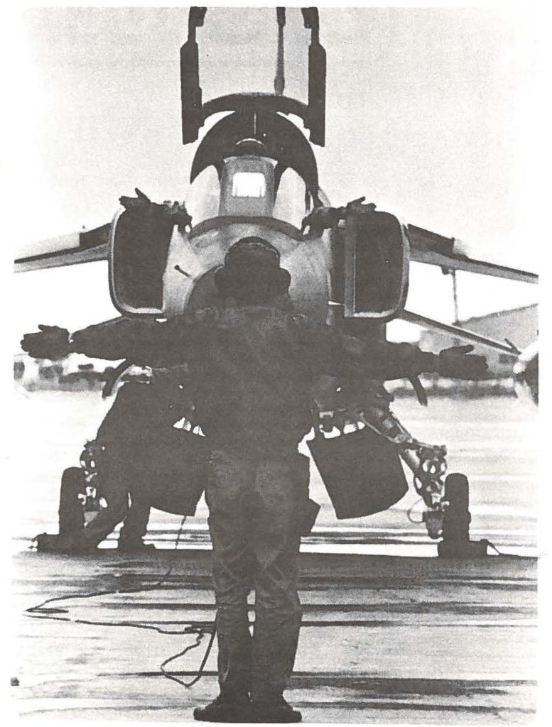 This JASDF pilot is not putting his arms up in despair; he's just responding to the crew chiefs signal to begin his taxi.
