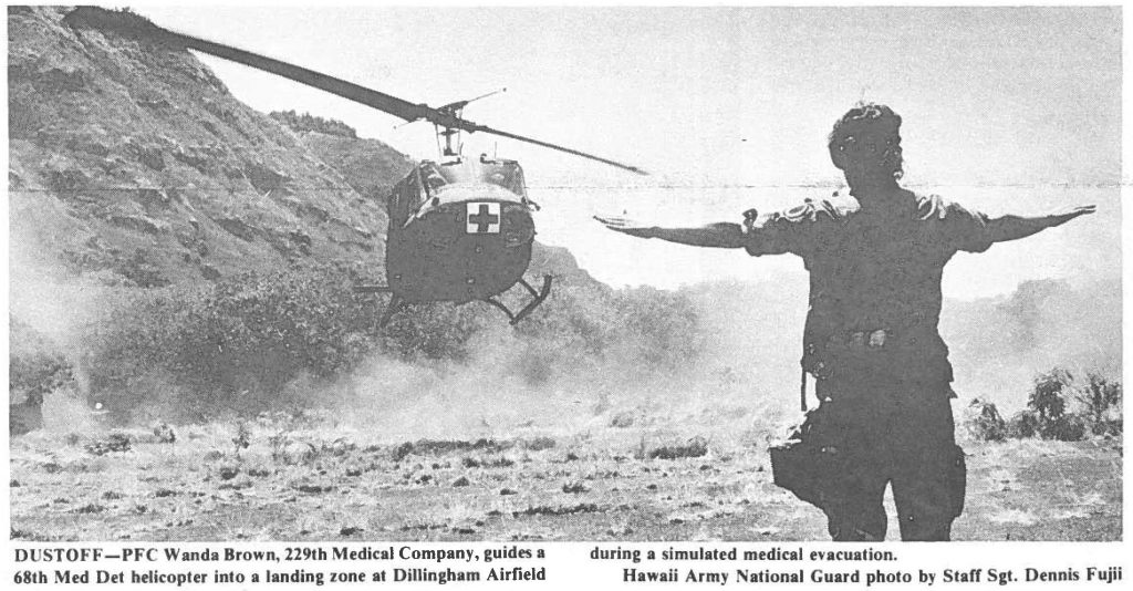 DUST OFF-PFC Wanda Brown, 229th Medical Company, guides a 68th Med Det helicopter Into a landing zone at Dillingham Airfield during a simulated medical evacuation. Hawaii Army National Guard photo by Staff Sgt. Dennis Fujii