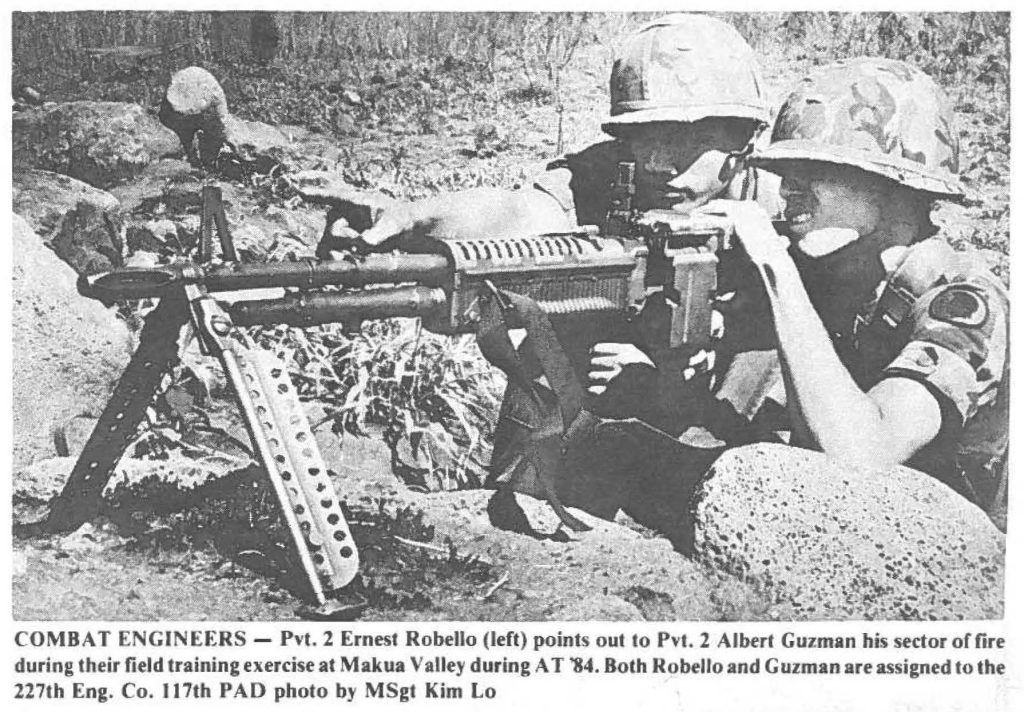 COMBAT ENGINEERS - Pvt. 2 Ernest Robello (left) points out to Pvt. 2 Albert Guzman his sector of fire during their field training exercise at Makua Valley during AT '84. Both Robello and Guzman are assigned to the 227th Eng. Co. 117th PAD photo by MSgt Kim Lo