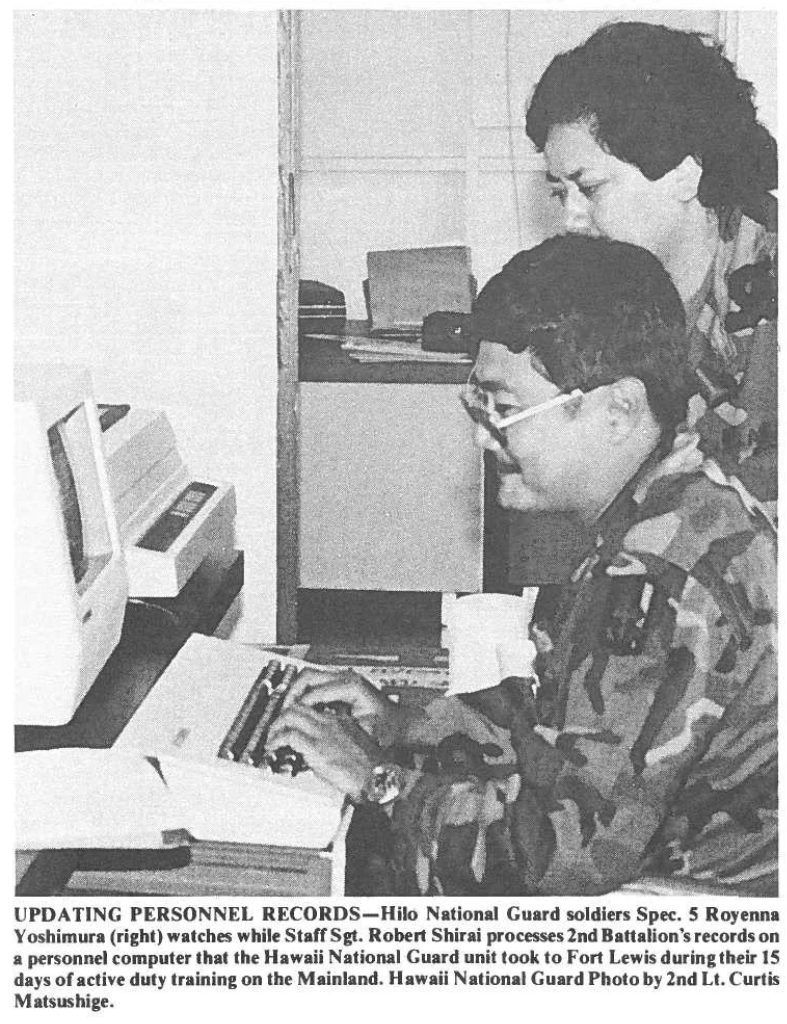 UPDATING PERSONNEL RECORDS-Hilo National Guard soldiers Spec. S Royenna Yoshimura (right) watches while Staff Sgt. Robert Shirai processes 2nd Battalion's records on a personnel computer that the Hawaii National Guard unit took to Fort Lewis during their 15 days of active duty training on the Mainland. Hawaii National Guard Photo by 2nd Lt. Curtis Matsushige.