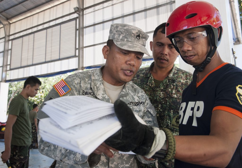 U.S. Army Staff Sgt. Jim Evagelista, left, 103rd Troop Command, 230th Engineer Company logistics noncommissioned officer in charge, Hawaii Army National Guard, instructs Ruel Tabang, right, Palawan Puerto Princesa City Bureau of Fire Protection rescuer, on basic shoring techniques for construction of a split sole raker as part of exercise Balikatan’s urban search and rescue training in Puerto Princesa City, Palawan, Philippines, April 24. The USAR training familiarized BK15 participants in lumber cutting and basic shoring, enabling them to more effectively construct T-spots and split soles in case a collapsing building needs to be supported during a real world mission. This year marks the 31st iteration of the exercise, which is an annual Philippines-U.S. bilateral military training exercise and humanitarian civic assistance engagement. (U.S. Air Force photo by Staff Sgt. Christopher Hubenthal/Released)