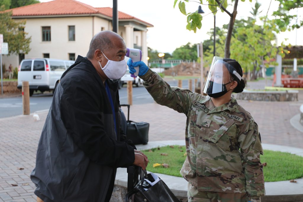 PV2 Cortney Tabujara, carpentry and masonry specialist with the Hawaii Army National Guard, 230th Engineer Company, assigned to Task Force Maui assist community liaisons with temperature screening and crowd control at the harbor in Lahaina, HI, August 21, 2020.