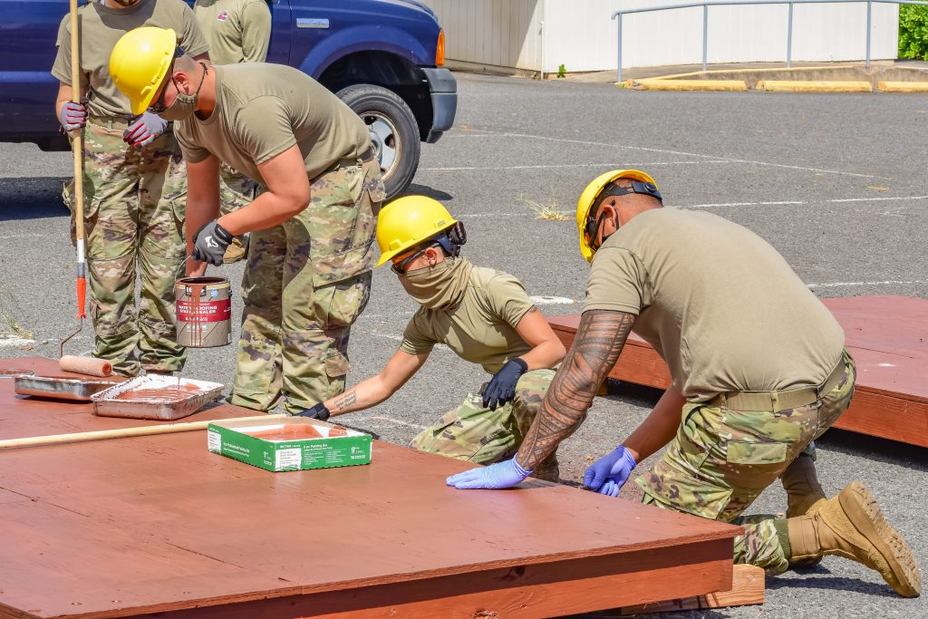 Hawaii Army National Guard Soldiers with 230th Engineer Company, 103rd Troop Command, utilize their technical expertise to paint and seal wooden platforms they've constructed that will help Maui county residents affected by the coronavirus during the COVID-19 pandemic, Kahului, Hawaii, June 3, 2020. (U.S. Army National Guard photo by Sgt. 1st Class Theresa Gualdarama)