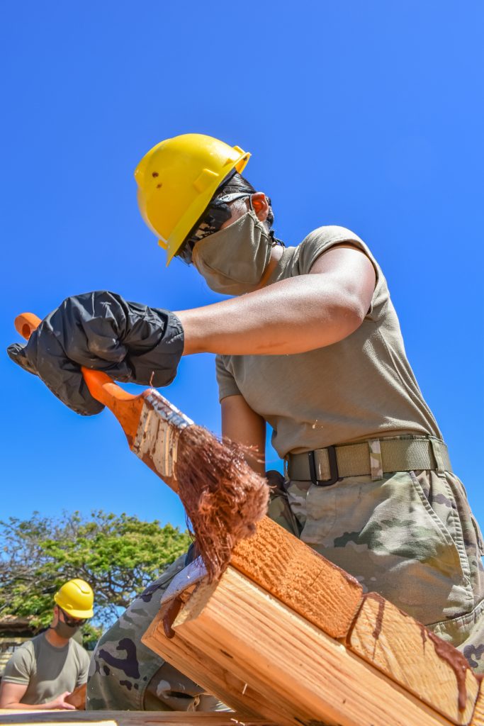 Spc. Melit Soco, Electrician with 230th Engineer Company, 103rd Troop Command, Hawaii Army National Guard utilize her technical skills to apply paint sealer to wooden platforms they've constructed to help Maui county residents affected by the coronavirus during the COVID-19 pandemic, Kahului, Hawaii, June 3, 2020. (U.S. Army National Guard photo by Sgt. 1st Class Theresa Gualdarama)