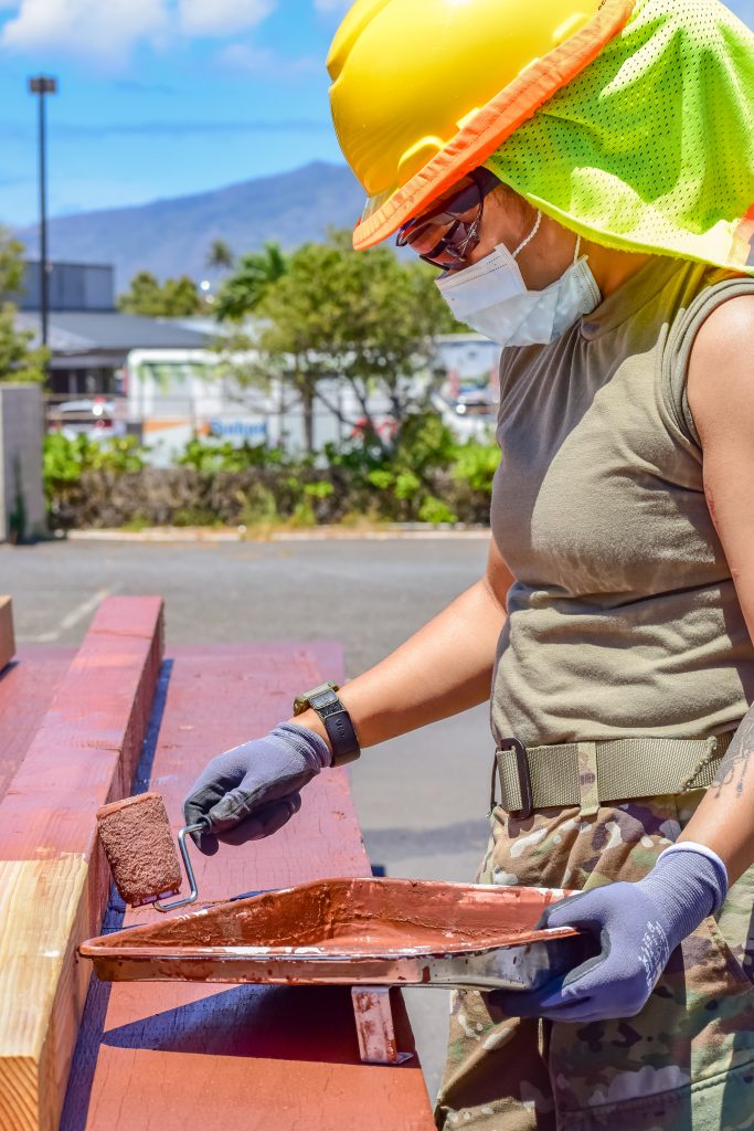 Pfc. Shamica Segundo, Automated Logistical Specialist with 230th Engineer Company, 103rd Troop Command, Hawaii Army National Guard utilize her technical skills to apply paint sealer to wooden platforms they've constructed to help Maui county residents affected by the coronavirus during the COVID-19 pandemic, Kahului, Hawaii, June 3, 2020. (U.S. Army National Guard photo by Sgt. 1st Class Theresa Gualdarama)