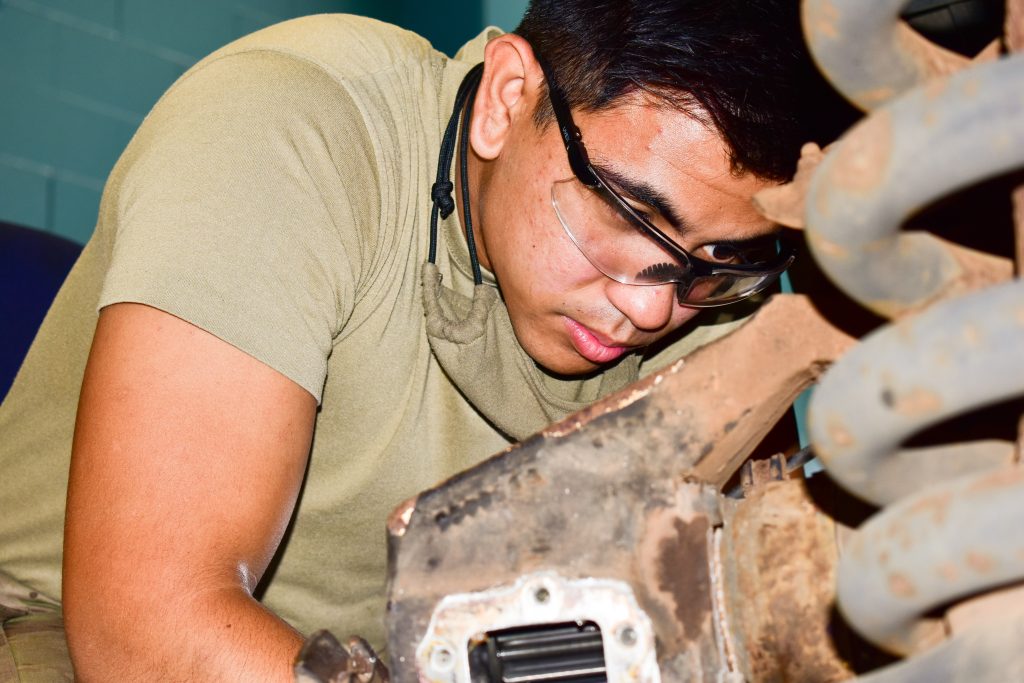 Spc. Oscar Gutierrez, a Wheeled Vehicle Mechanic with 230th Engineer Company, 103rd Troop Command, Hawaii Army National Guard utilizes his expertise to repair the rear geared hub of a High Mobility Multipurpose Wheeled Vehicle on the island of Maui during COVID-19 operations, Kihei, Hawaii, May 6, 2020. (U.S. Army National Guard photo by Sgt. 1st Class Theresa Gualdarama)