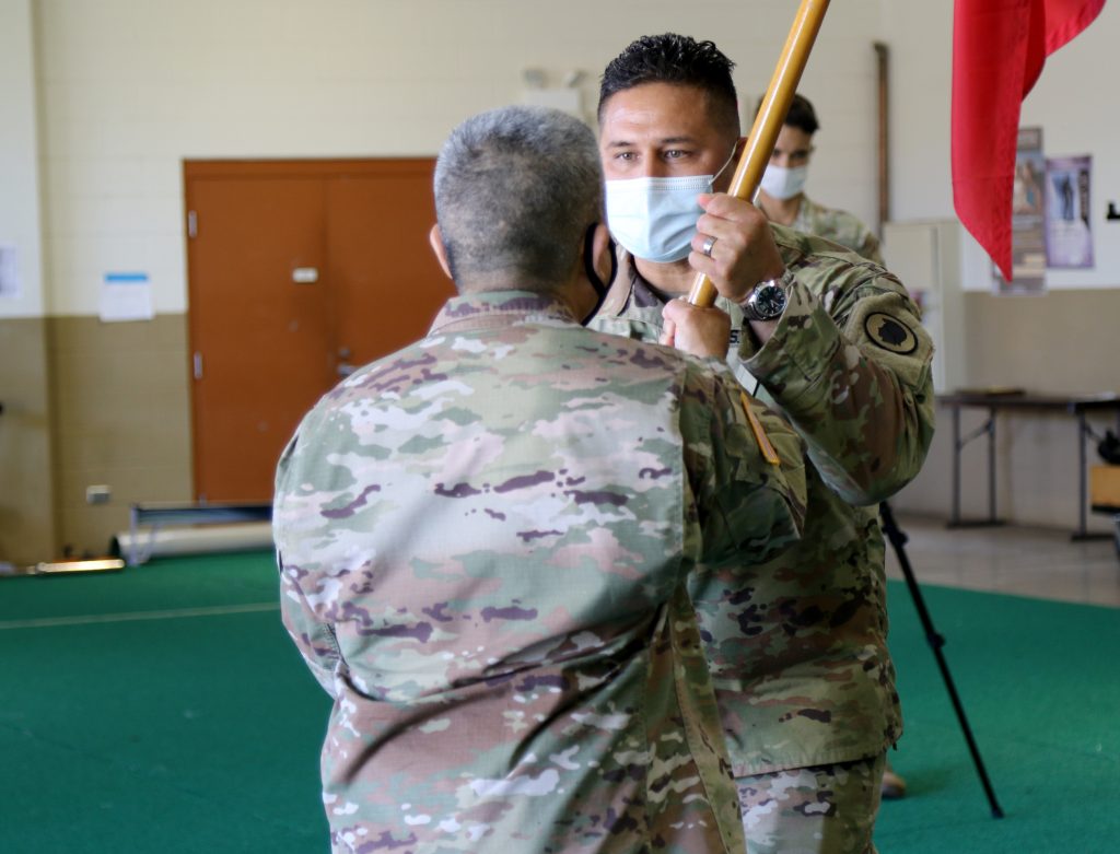 Hawaii Army National Guard Capt. Ramon H. Garza receives the unit guidon from 1st Sgt. Melvin H. Tokuda relinquishing her command duties to Capt. Joshua H.D. Aquinde during the 230th Engineer Company Change of Command ceremony, held at 103rd Troop Command, Pearl City, Hawaii, Oct. 16, 2021. A change of command ceremony symbolizes the exchange from one command to the next. (U.S. Army National Guard photo by Sgt. Matthew A. Foster)
