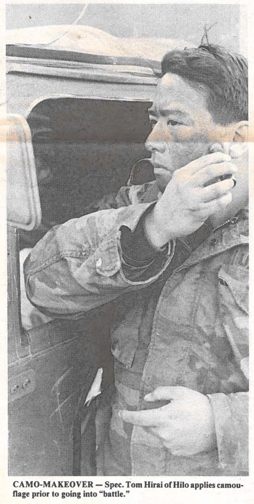 CAMO-MAKEOVER - Spec. Tom Hirai of Hilo applies camouflage prior to going into "battle".