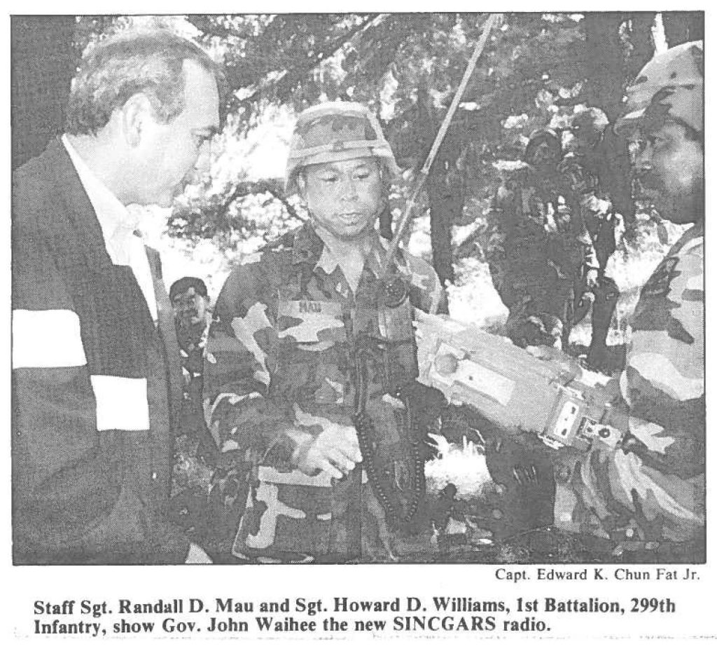 Staff Sgt. Randall D. Mau and Sgt. Howard D. Williams, 1st Battalion, 299th Infantry, show Gov. John Waihee the new SINCGARS radio