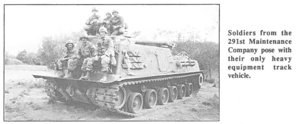 Soldiers from the 291st Maintenance Company pose with their only heavy equipment track vehicle.