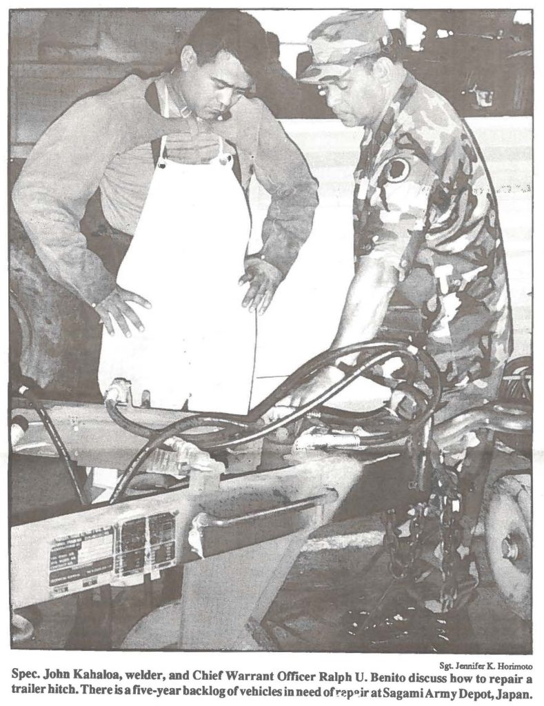 Spec. John Kahaloa, welder, and Chief Warrant Officer Ralph U. Benito discuss how to repair a trader hitch. There is a five-year backlog of vehicles in need of repair at Sagami Army Depot, Japan.