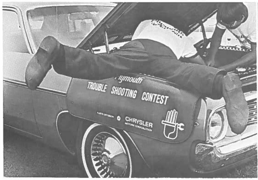 The Honolulu Comnuinty College team of Gordon T. Tanagawa and Jeffrey J. Jong work hand and foot at solving problems in Hawai, 56th annual Automotive Trouble Shooting Contest. The team rode their efforts to first place.