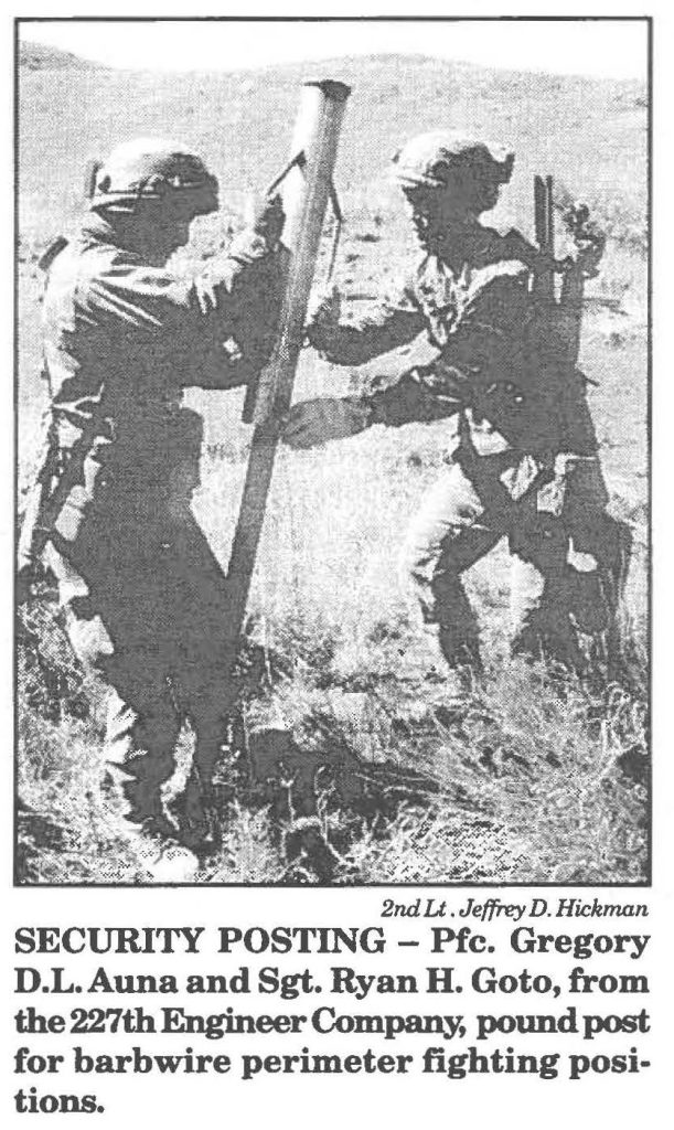 SECURITY POSTING - Pfc. Gregory D.L. Auna and Sgt. Ryan H. Goto, from the 227th Engineer Company, pound post for barbwire perimeter fighting positions.