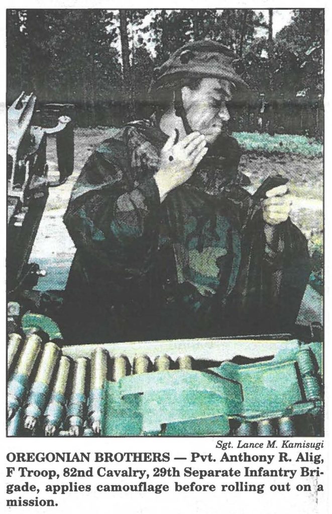 OREGONIAN BROTHERS - Pvt. Anthony R. Alig, F Troop, 82nd Cavalry, 29th Separate Infantry Brigade, applies camouflage before rolling out on a mission.