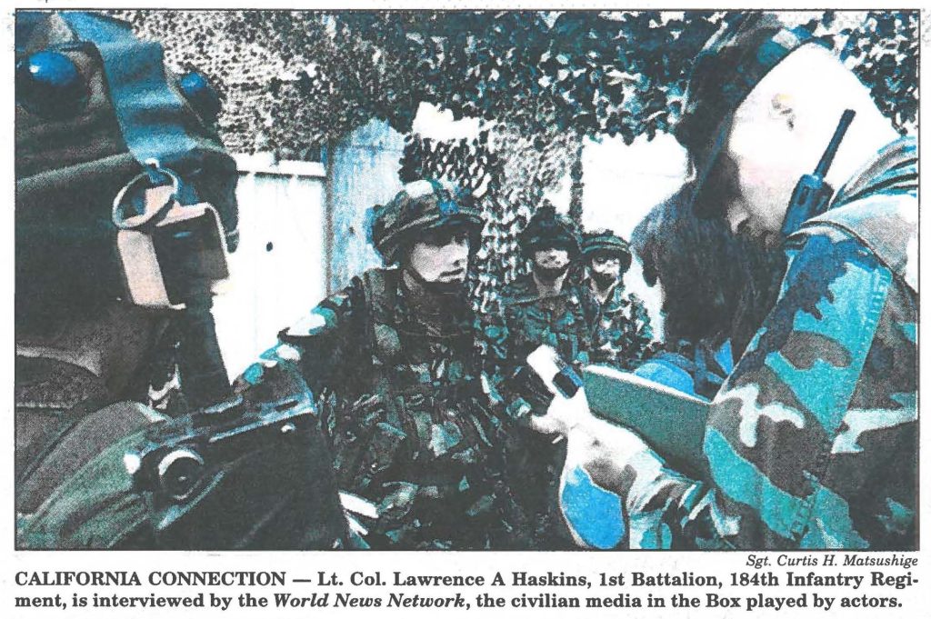 CALIFORNIA CONNECTION - Lt. Col. Lawrence A Haskins, 1st Battalion, 184th Infantry Regiment, is interviewed by the World News Network, the civilian media in the Box played by actors.