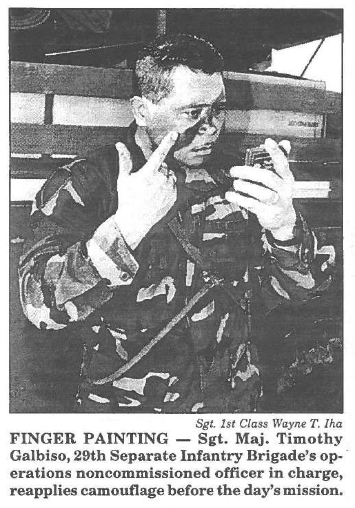 FINGER PAINTING - Sgt. Maj. Timothy Galbiso, 29th Separate Infantry Brigade's operations noncommissioned officer in charge, reapplies camouflage before the day's mission