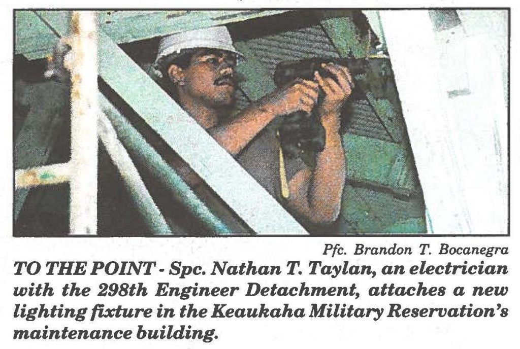TO THE POINT- Spc. Nathan T. Taylan, an electrician with the 298th Engineer Detachment, attaches a new lighting fixture in the Keaukaha Military Reservation's maintenance building